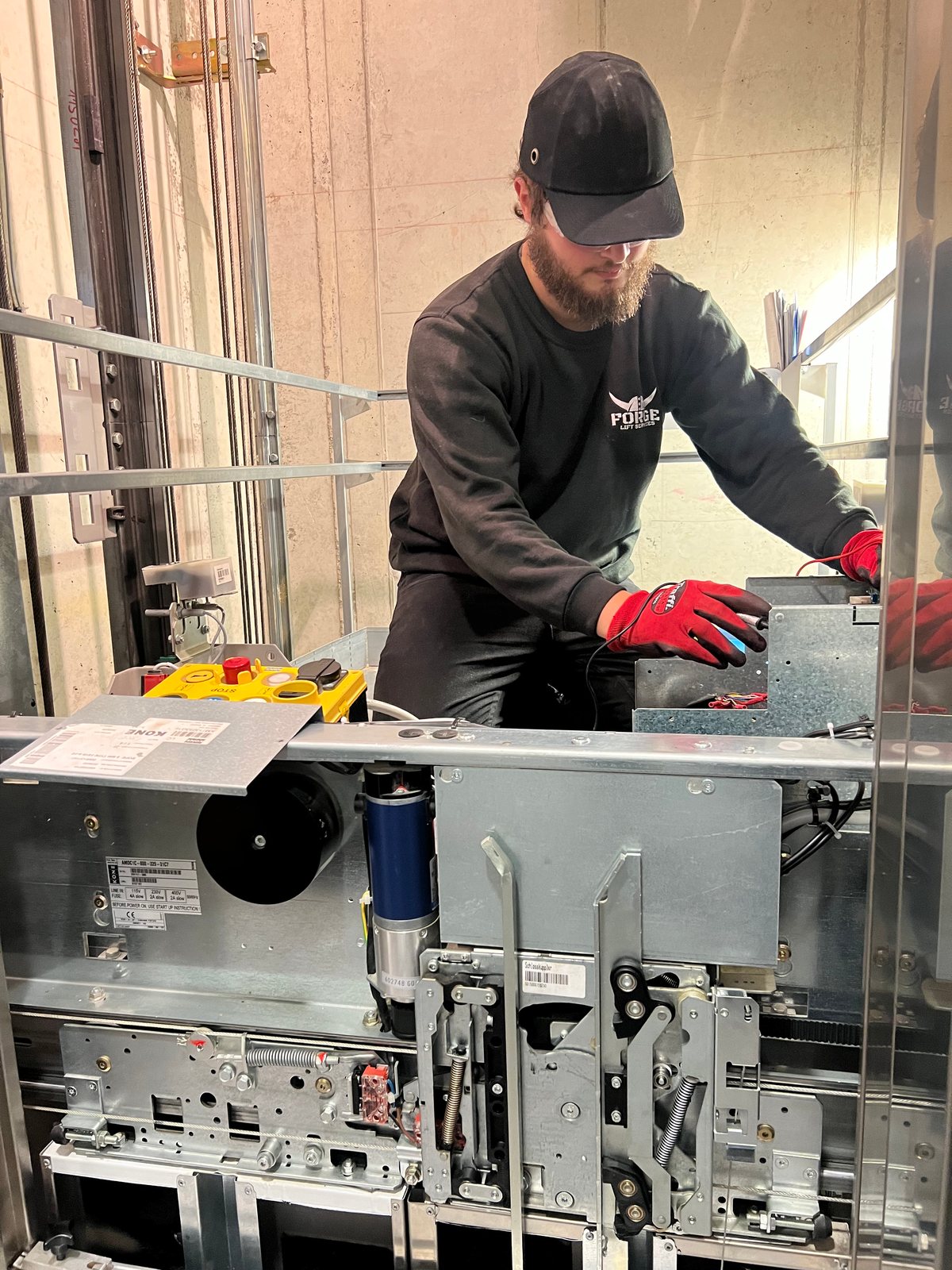 Forge Lifts engineer working on lift door equipment
